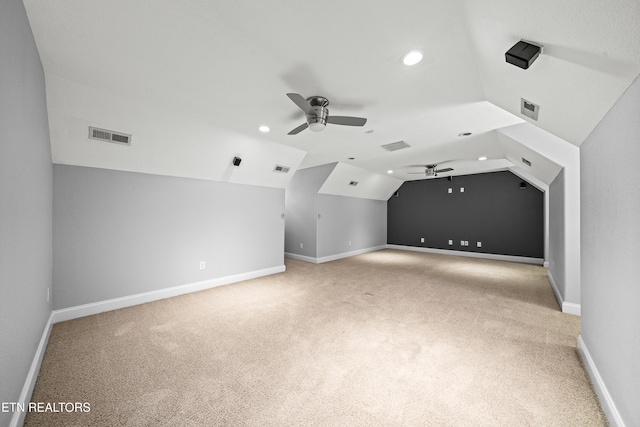 bonus room with vaulted ceiling and light carpet