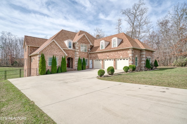 view of front of property featuring a garage and a front lawn