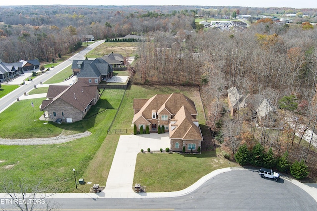 drone / aerial view with a view of trees and a residential view