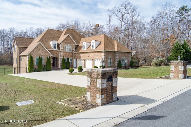 view of front of home with a front lawn and a garage