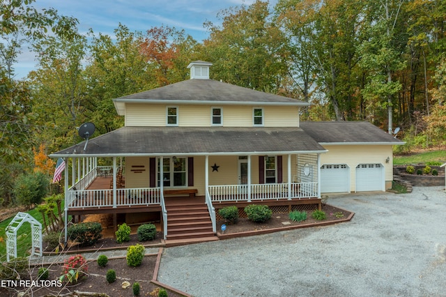 country-style home with a garage and a porch