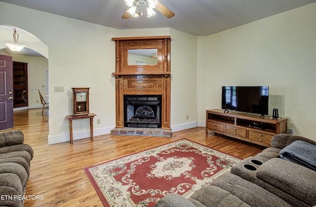 living room with ceiling fan and wood-type flooring