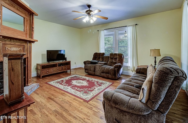 living room featuring ceiling fan and light wood-type flooring