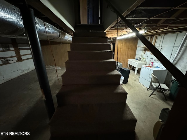 basement with washer / clothes dryer and sink