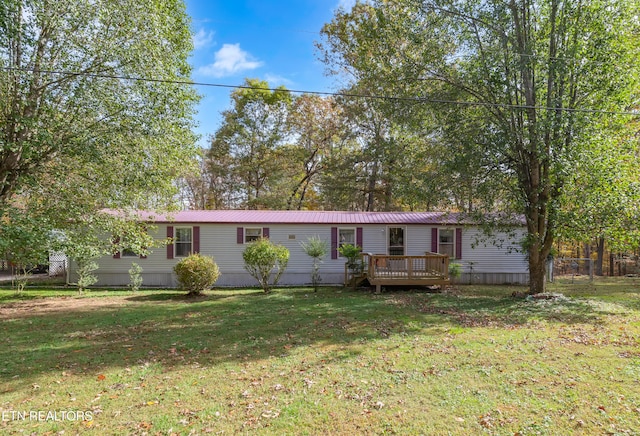 view of front of property featuring a front yard and a wooden deck