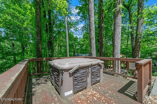 wooden terrace featuring a hot tub