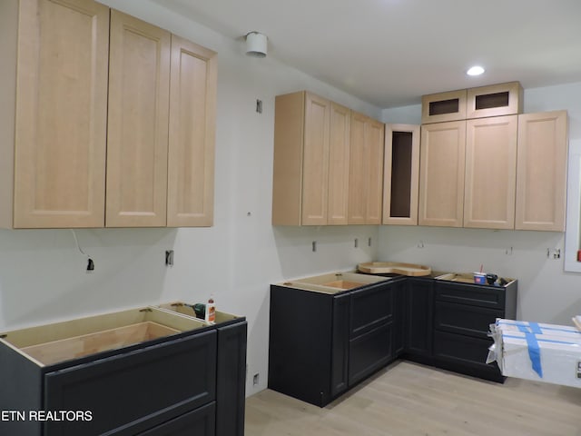 kitchen with light brown cabinetry and light wood-type flooring