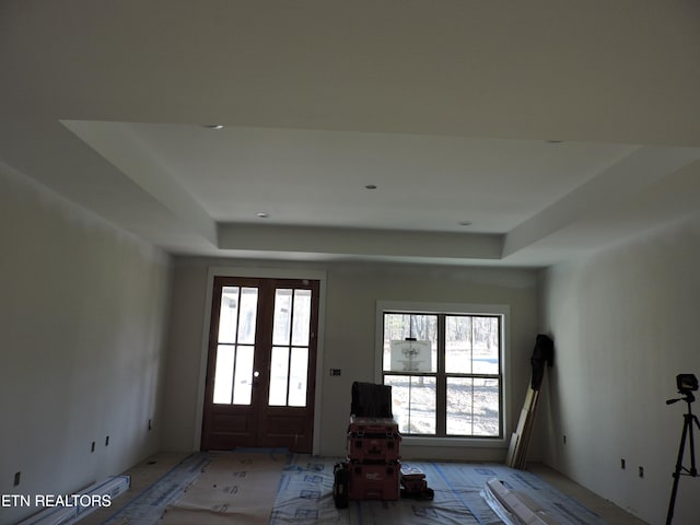 foyer entrance with a raised ceiling and french doors