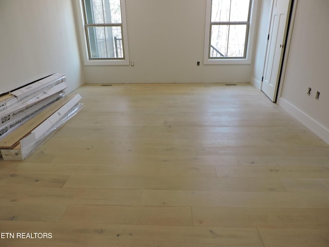 spare room with light wood finished floors