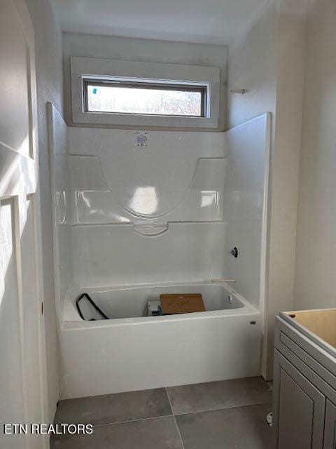 bathroom featuring vanity, bathtub / shower combination, and tile patterned flooring