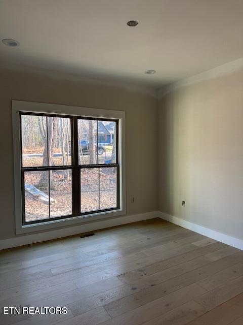 empty room with hardwood / wood-style flooring