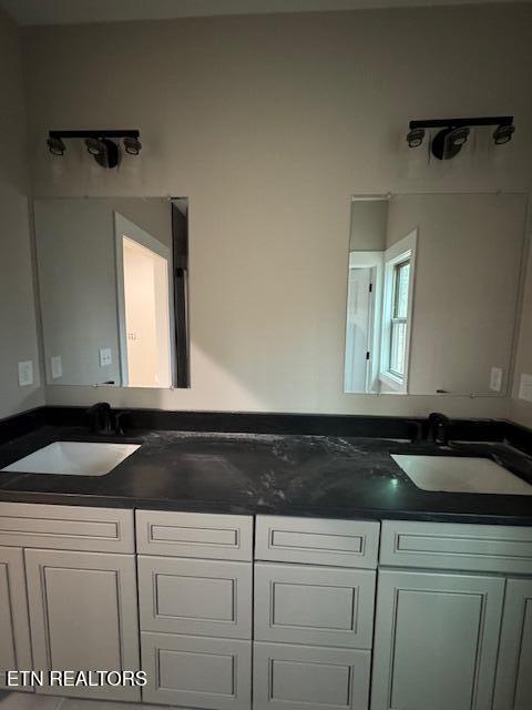 bathroom featuring double vanity and a sink