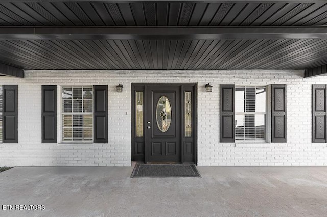 view of exterior entry with a porch