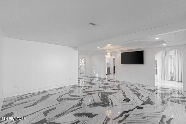 unfurnished living room with a textured ceiling