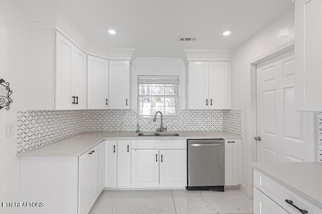 kitchen featuring tasteful backsplash, white cabinetry, sink, and stainless steel dishwasher