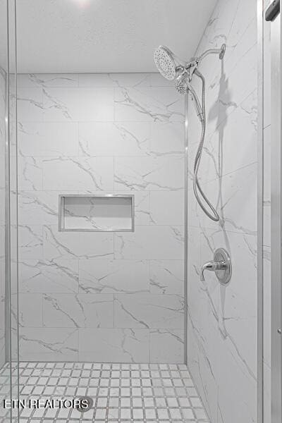 bathroom with tiled shower