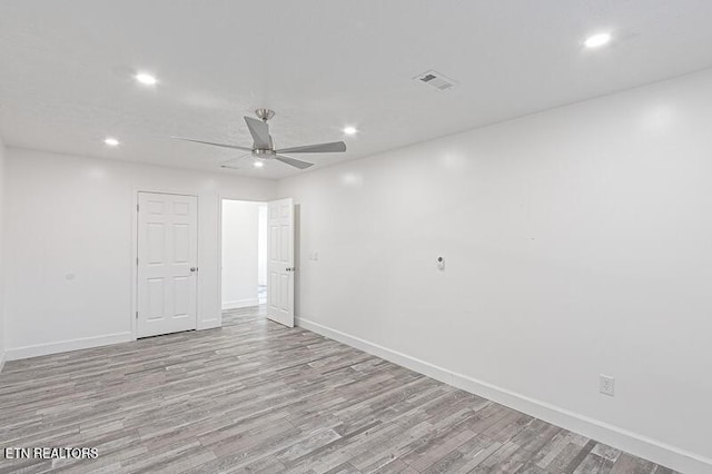 unfurnished room with ceiling fan and light hardwood / wood-style flooring