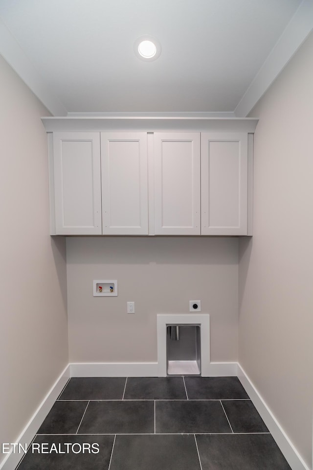 laundry room with washer hookup, cabinets, electric dryer hookup, and dark tile patterned floors