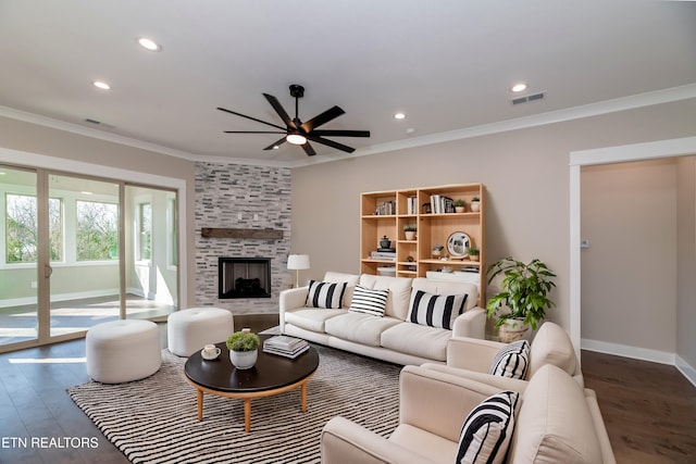 living room with a fireplace, ornamental molding, hardwood / wood-style floors, and ceiling fan