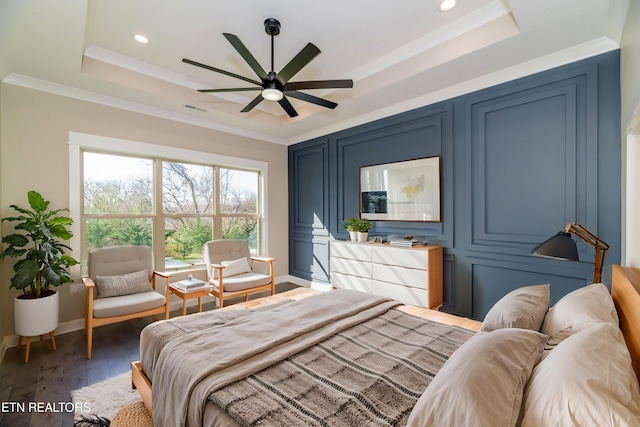 bedroom with ornamental molding, a raised ceiling, and dark hardwood / wood-style floors