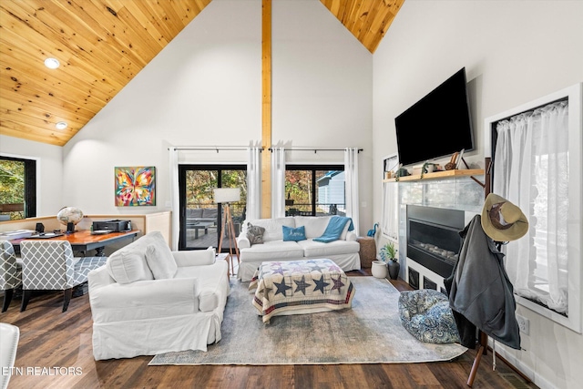 living room with high vaulted ceiling, wood-type flooring, and a healthy amount of sunlight