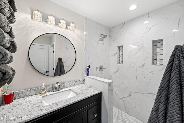 bathroom with vanity and a tile shower