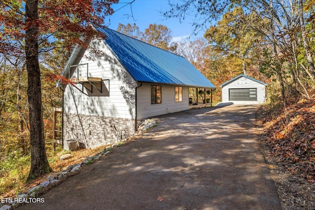 view of home's exterior with an outbuilding and a garage