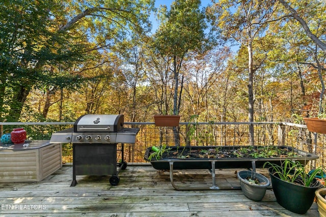 wooden terrace featuring grilling area