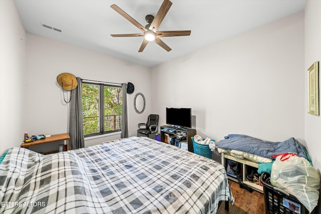 bedroom featuring dark hardwood / wood-style flooring and ceiling fan