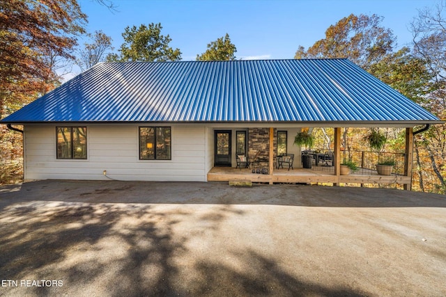 rear view of property featuring a deck