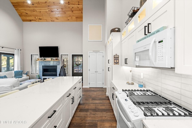 kitchen with backsplash, wood ceiling, white cabinets, dark wood-type flooring, and white appliances