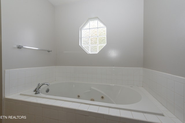 bathroom featuring a relaxing tiled tub