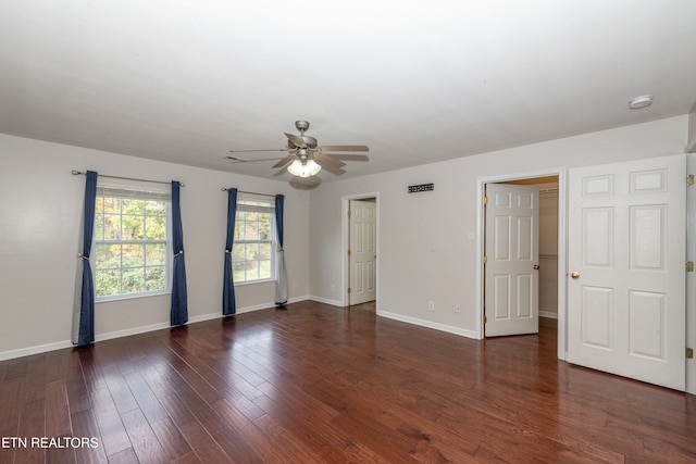 spare room with ceiling fan and dark hardwood / wood-style flooring