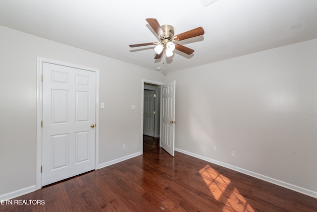 unfurnished bedroom with dark hardwood / wood-style floors and ceiling fan