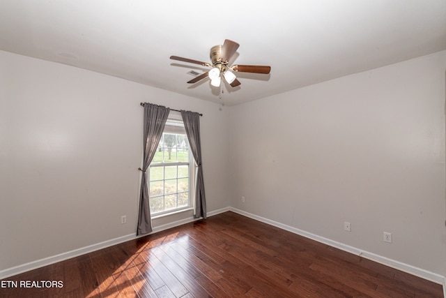 spare room featuring dark hardwood / wood-style floors and ceiling fan