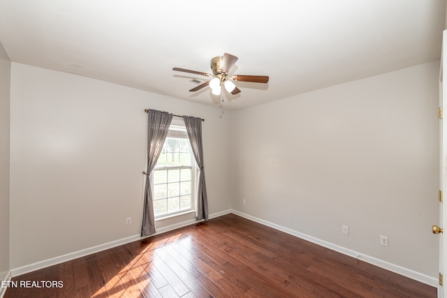 empty room with dark wood-type flooring and ceiling fan