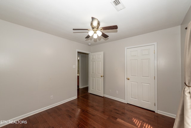 unfurnished bedroom featuring dark hardwood / wood-style flooring and ceiling fan