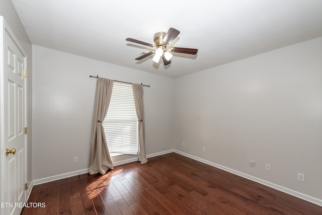 spare room with dark wood-type flooring and ceiling fan