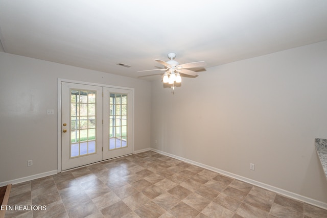 unfurnished room featuring french doors and ceiling fan