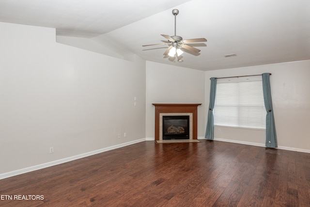 unfurnished living room with dark wood-type flooring, lofted ceiling, and ceiling fan