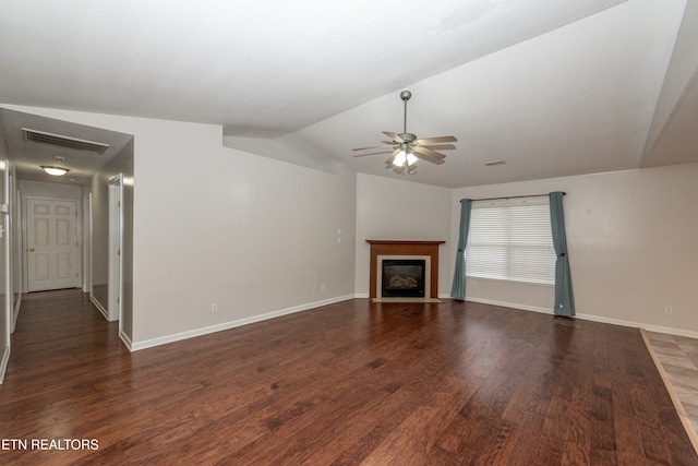 unfurnished living room with ceiling fan, dark hardwood / wood-style floors, and vaulted ceiling