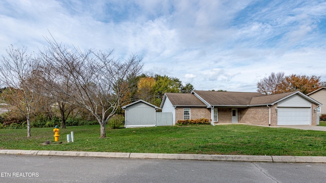 view of front facade with a garage and a front lawn