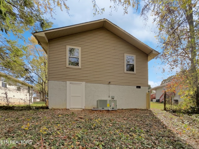 rear view of property featuring cooling unit