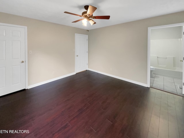 empty room featuring dark hardwood / wood-style flooring and ceiling fan