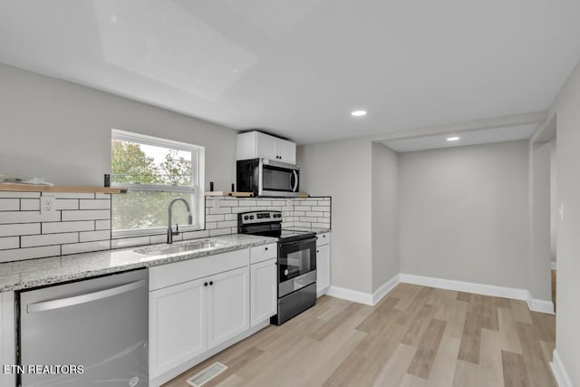 208 Collins St, Loudon, TN 37774 - kitchen featuring white cabinetry, light hardwood / wood-style floors, appliances with stainless steel finishes, and sink