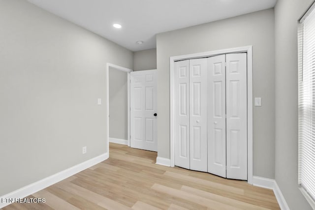 208 Collins St, Loudon, TN 37774 - unfurnished bedroom featuring light hardwood / wood-style floors, multiple windows, and a closet