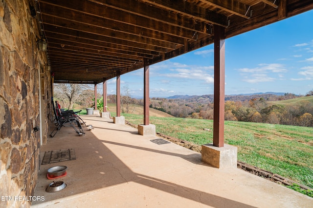 view of patio / terrace with a mountain view and a rural view