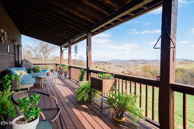 wooden deck featuring a lawn