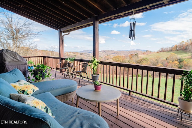 wooden deck featuring a lawn