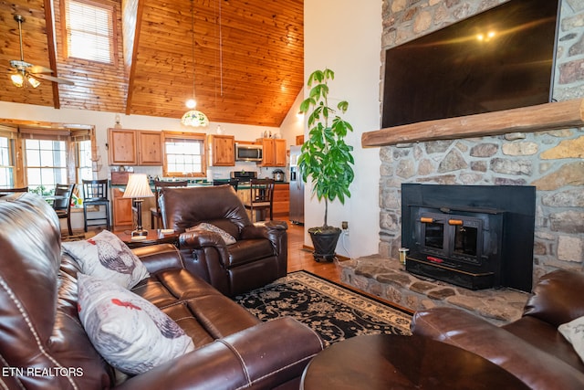 living room with wooden ceiling, hardwood / wood-style flooring, ceiling fan, and high vaulted ceiling